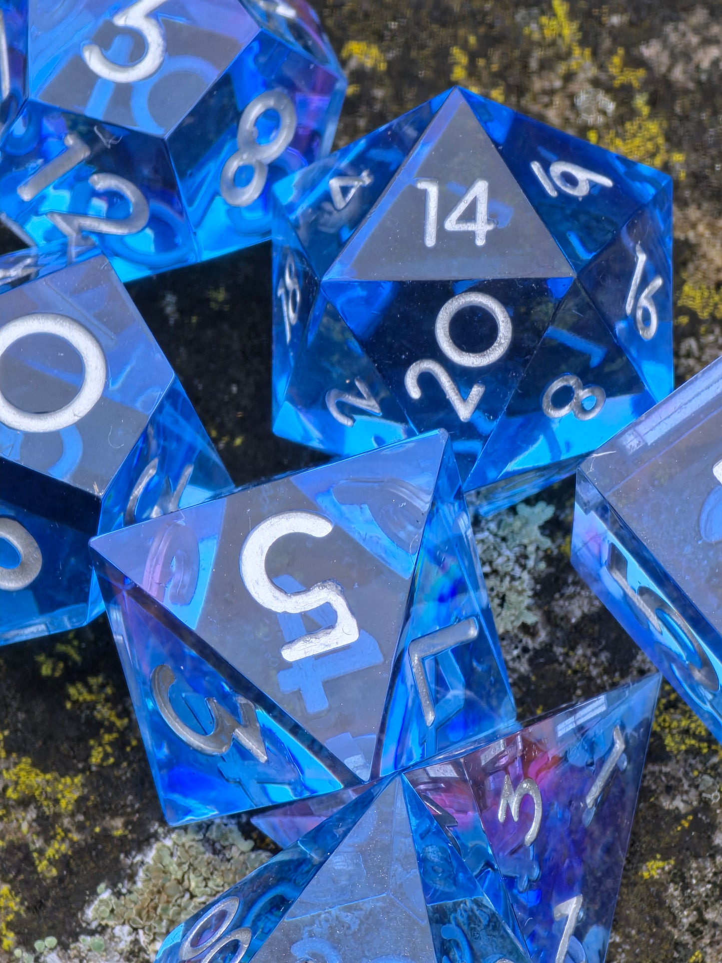 Abyss of the Sapphire Tide“ – handgemachtes DnD Würfelset aus klarem tiefblauem Resin mit silbernen Zahlen.  
Abyss of the Sapphire Tide” – handmade DnD dice set in clear deep blue resin with silver numbers.