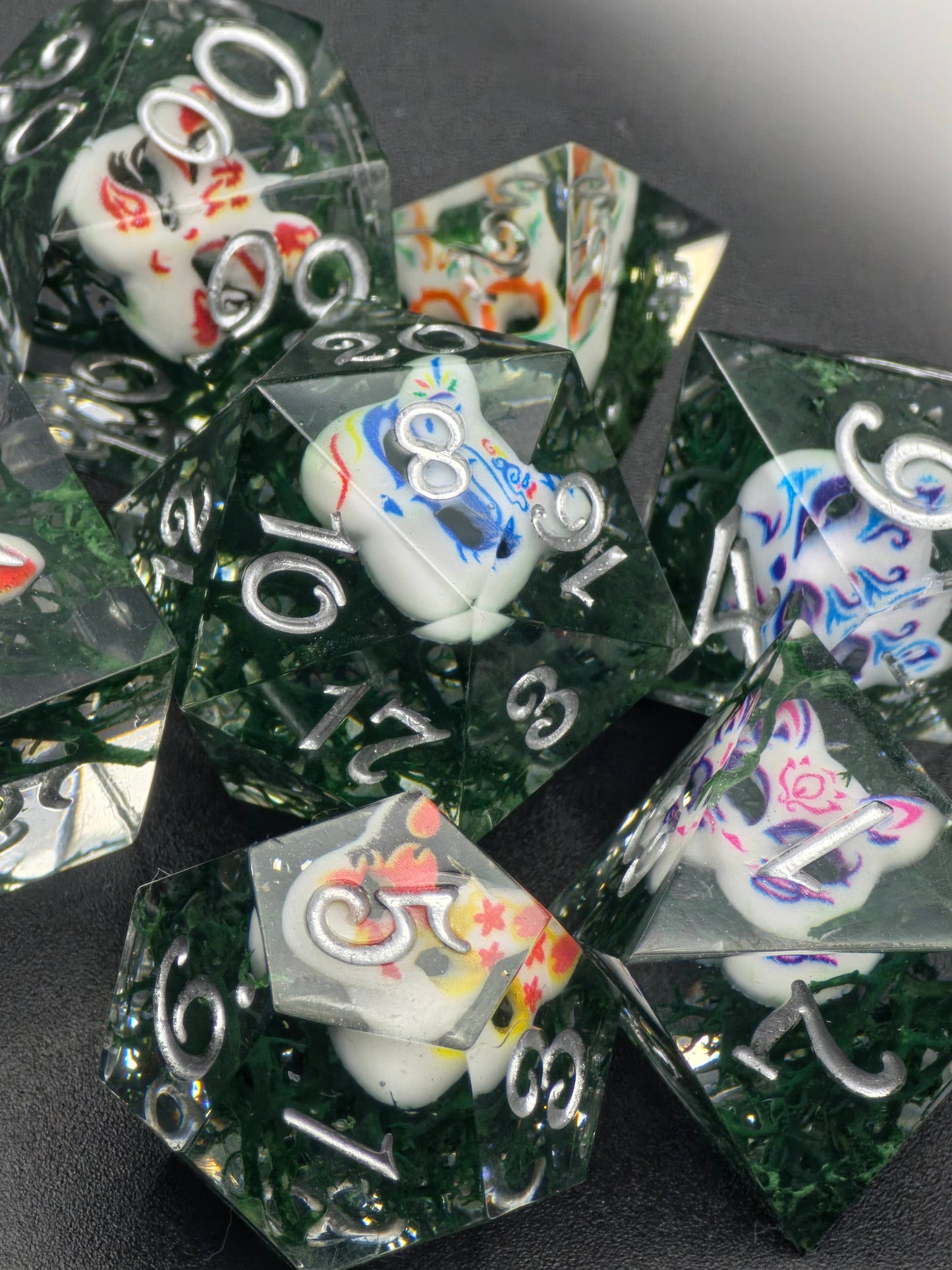 Kitsune Spirit Dice“ – handgemachtes DnD Würfelset aus klarem Resin mit japanischen Fuchs-Masken und weißen Zahlen.  
Kitsune Spirit Dice” – handmade DnD dice set in clear resin with Japanese fox mask designs and white numbers.