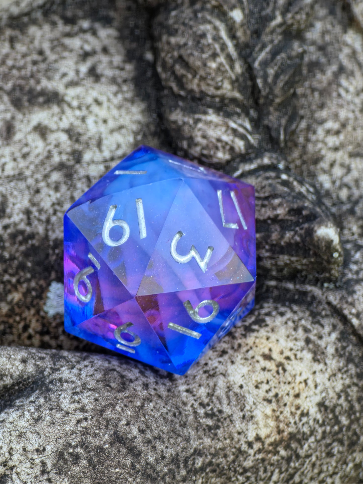 Detailaufnahme des „Cloud Blossom Nebula“ Würfels – zeigt leuchtende Farbwirbel und gläserne Harzstruktur.  
Close-up of the “Cloud Blossom Nebula” die – showing luminous color swirls and glass-like resin structure.