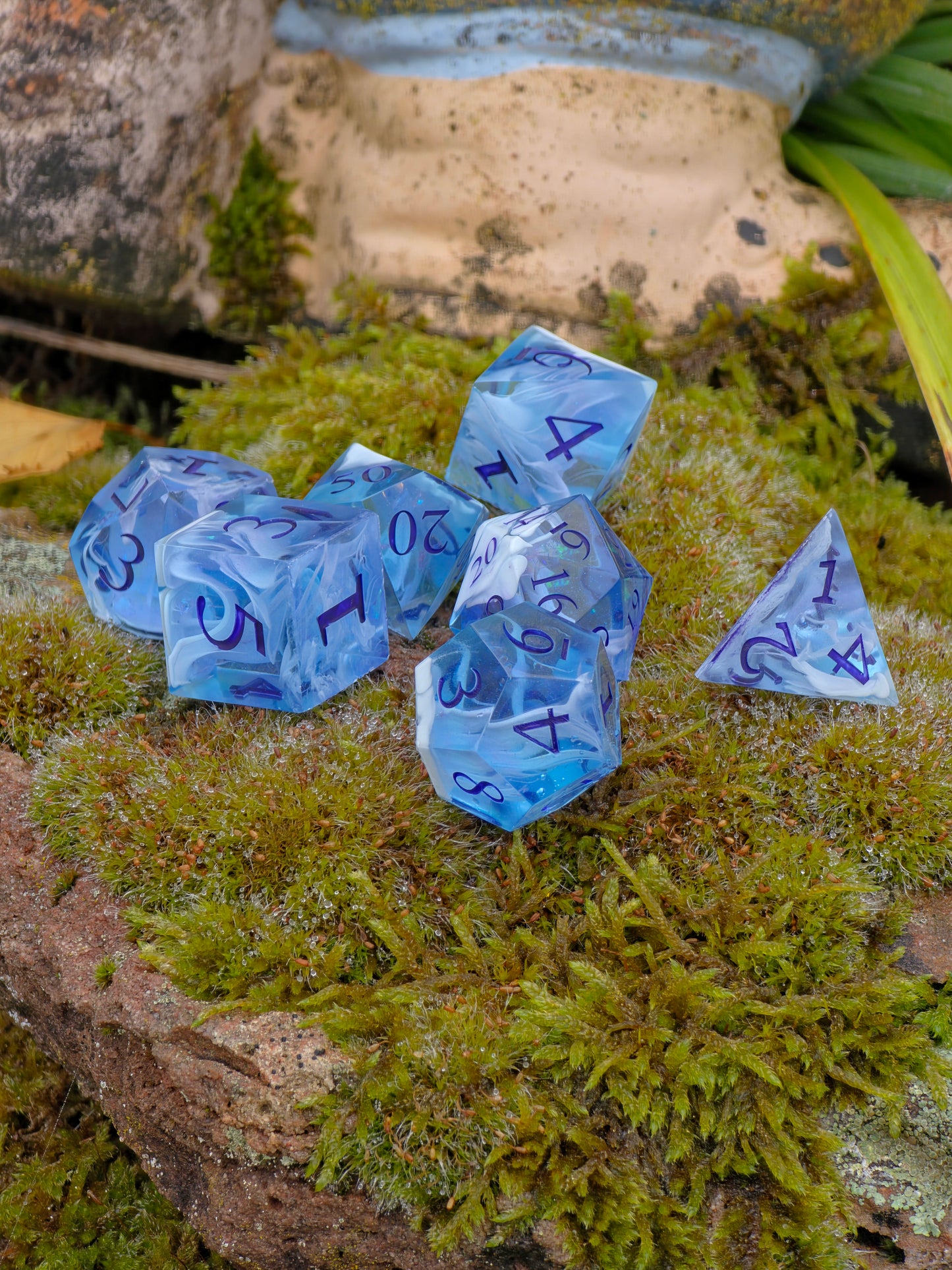 Handgemachtes DnD Würfelset „Himmel im Hand“ – 7 Stück in transparentem Himmelblau mit Wolkenmuster.  
Handmade DnD dice set “Sky in Hand” – 7 pieces in transparent sky blue with soft cloud pattern.